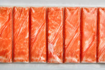 Crab sticks or imitation crab meat surimi in a package top view