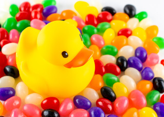 Rubber duck surrounded by assorted jelly beans.