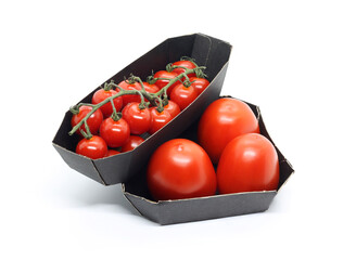 Fresh plum tomatoes and cherry tomatoes in cardboard containers for sale in a supermarket. Natural product in eco-friendly packaging. Isolated on white background.