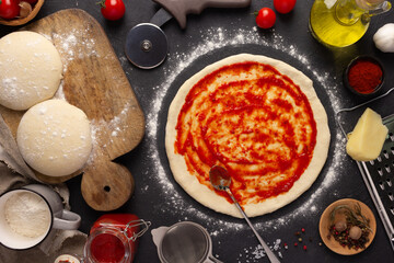 Pizza homemade cooking or baking on table. Dough pizza  at slate tabletop background