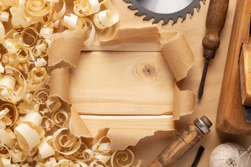 Plane jointer carpenter or joiner tool and wood shavings. Torn paper and woodworking tools