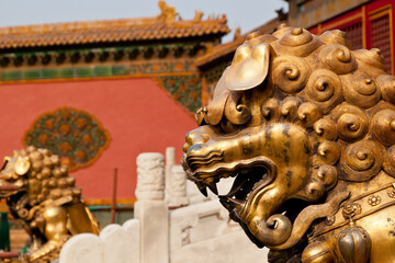 Golden Lion statue and historical architecture in Forbidden City in Beijing, China