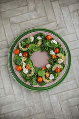 Spinach, kale, cherry tomato, burrata, mozzarella and avocado salad with sesame and flax seeds. A healthy lunch of fresh vegetables, cheese and young greens. Unusual food styling