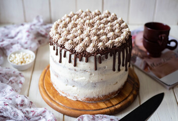 Delicious dessert: Cream cake with whipped cream on a white background. Close-up