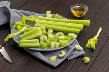 Chopped celery stalks on gray plate on napkin.