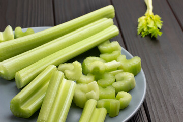 Chopped celery stalks on gray plate.