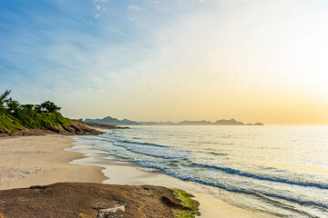 The small Devil beach located between Copacabana and Ipanema in Rio de Janeiro at dawn with the mountains in the background