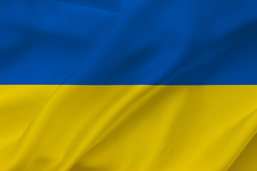 Ukraine flag on waving silk background. National flag with yellow and blue colors. Fabric texture.