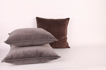 Three velvet pillows on a white background. Large