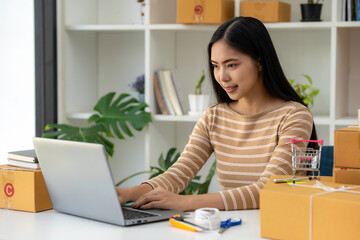 Asian business woman talking to clients on live video, selling online business. Working from home in webcam video social media in quarantine in corona virus