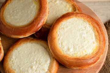 Homemade buns with cottage cheese on wooden background. Gluten free pastries.