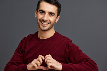 successful man posing smile gesture hands red sweater Gray background