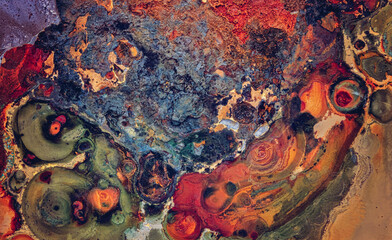 Abstract macro view of the paint and rust on the body of a car