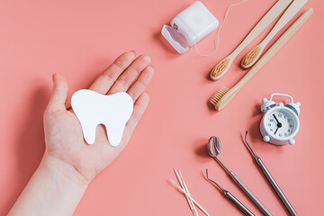 Hands holding paper cut mockup of tooth. Dental care concept. Happy dentist day.