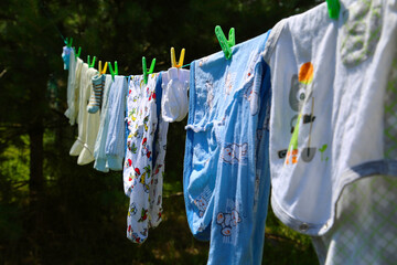 newborn's clothes are dried on a rope after washing in the sun