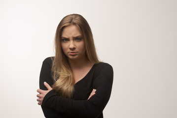 Obraz premium Angry young woman portrait in studio white background