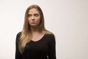 Obraz premium Angry young woman portrait in studio white background