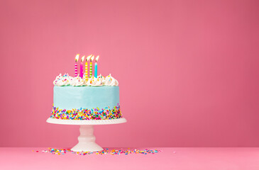 Blue Birthday Cake with Five Candles over Pink Background - 484988739
