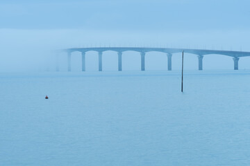 Fototapeta na wymiar Ile de Ré bridge over the sea with fog. view from Rivedoux