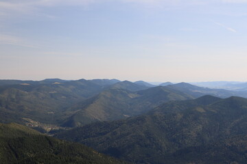view of the wild mountainous area in the Carpathians from a height in the haze