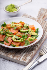 Fresh salmon salad with avocado,  for keto and low carb diet. Rusty background, top view, copy space.