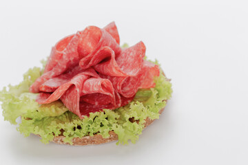 Sandwich with salami sausage on white background.