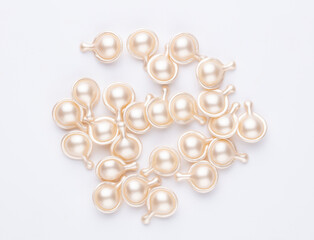 Hyaluronic acid capsules isolated on white background.