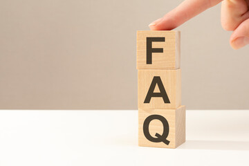FAQ - letters abbreviation on wooden cubes on a gray background