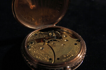 Old pocket watch with folding gold cover