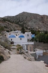 A beautiful Orthodox Church attached to the mountains at the famous black beach in Kamari Santorini Greece