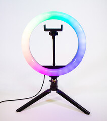 Ring lamp on a small tripod. Multicolored light.
