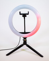 Ring lamp on a small tripod. The red light moves in a circle.