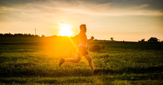 man running on meadow at sunset active lifestyle