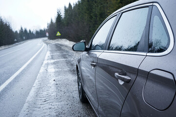 Obraz premium Car on a winter road in the forest. Road Trip Concept.