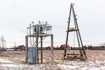 Fototapeta na wymiar Electricity pole and transformer on a winter day.