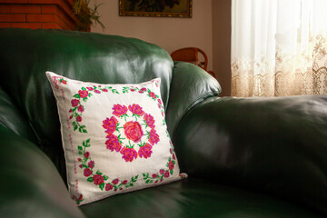 Handmade decorative pillow with rose embroidery.