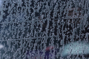 Frozen pattern of hoarfrost and frostwork structure on glass. Color photo for background. 