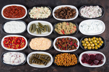 Mediterranean appetizer concept. Traditional Turkish cuisine. Middle Eastern appetizer with beetroot, olives, hummus, stuffed peppers, pickles, stuffed leaves, roasted peppers, roasted egg.