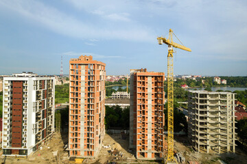 Aerial view of tall residential apartment buildings under construction. Real estate development.