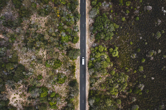 Traveling with campervan in Australia Road trip on a straight long road drone photo from the sky