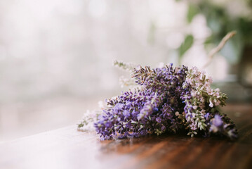 A bunch of lavender sitting on wood with blurry background