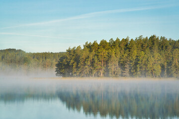 Naklejka na ściany i meble beautiful swedish lake in summertime with a blue sky