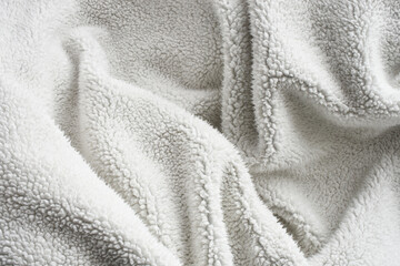 Fototapeta na wymiar An abstract image of the fluffy fibers on thick and comfy woolen blanket.