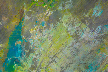 colorful creative motley background: smudged residues of oil paints on a wooden palette, short focus, selective blur