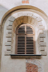 Old vintage arched window with wooden shutters. Armenian Church, Lviv.