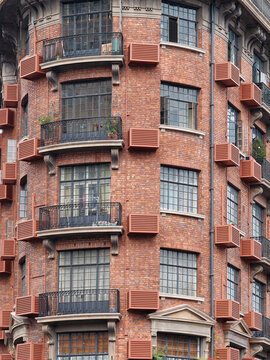 Close up view of Shanghai Wukang mansion, red brick wall and beautiful windows and flowers.