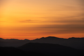 Fototapeta premium Faint Clouds Smear Over Mountain Ridges