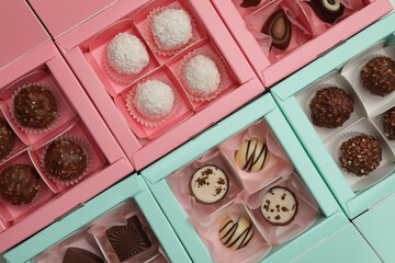 Many delicious candies in boxes, top view. Production line