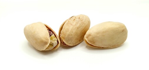 Pistachio nuts isolated. Delicious pistachio nuts on a white background. Salted nuts.