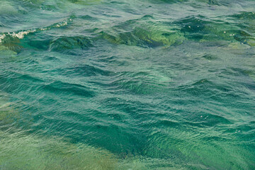 Waves on the surface of the turquoise tropical sea.